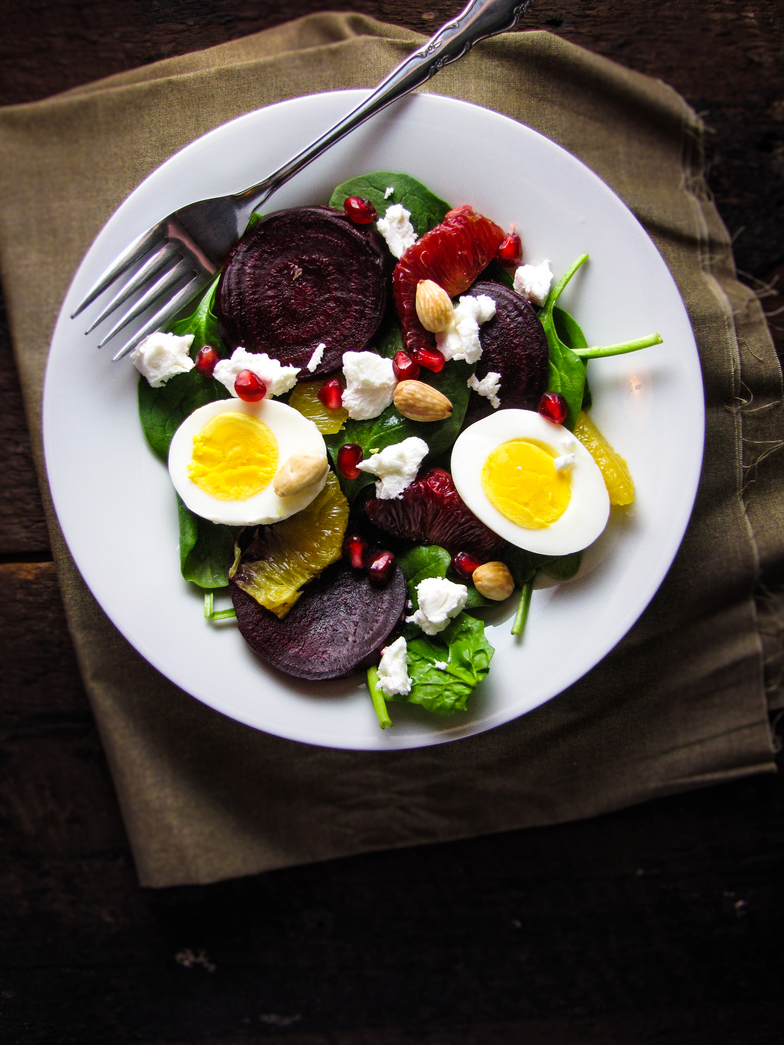 Roasted Beet and Spinach Salad with Goat Cheese, Eggs, Pomegranate, Orange, and Almond-Vinaigrette